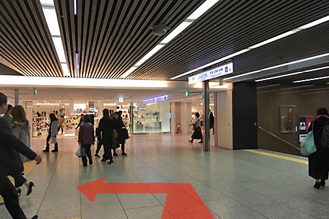 Get off the escalator and turn left.